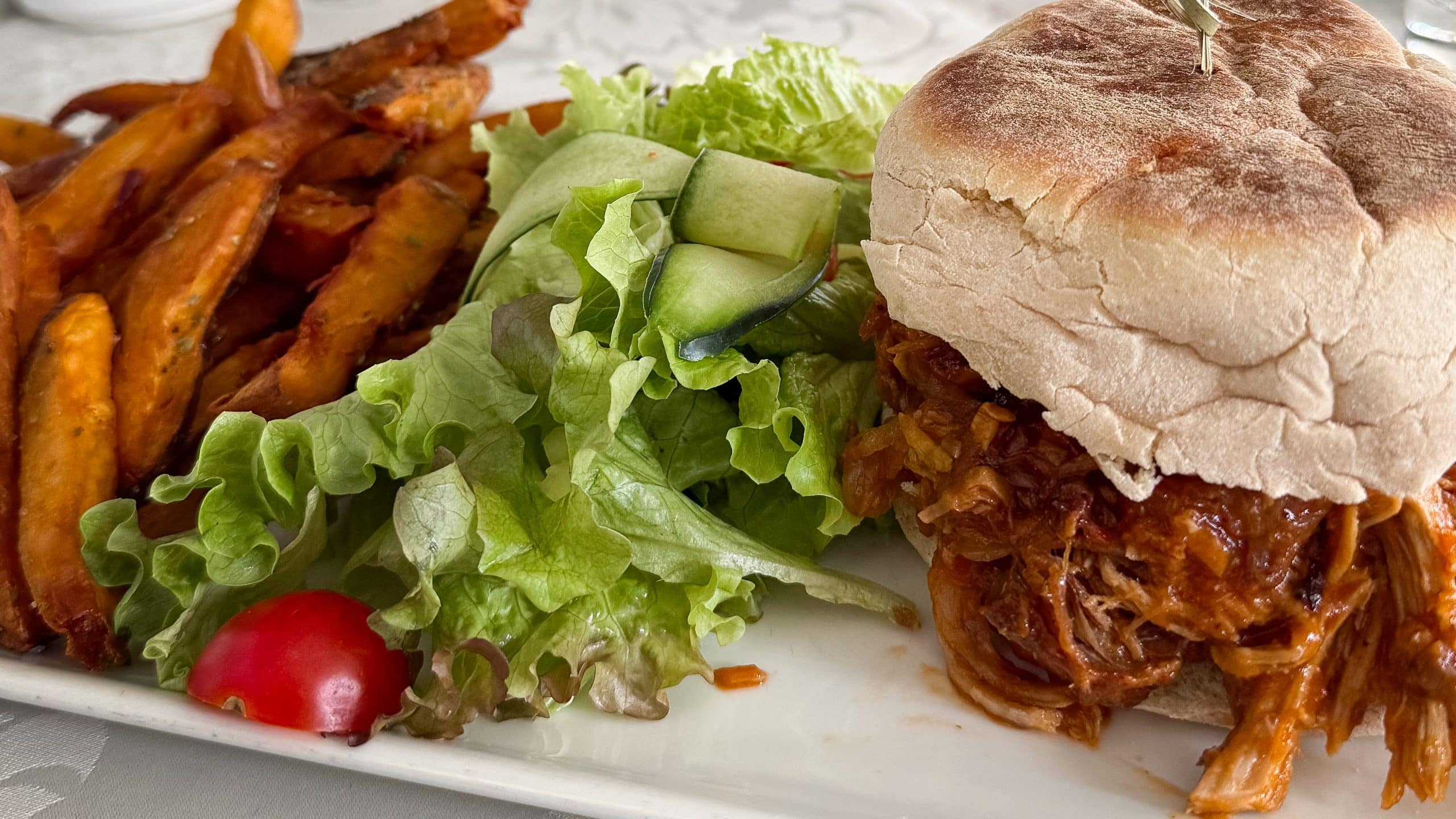 A pulled-pork burger in bolo do caco at Why Not?