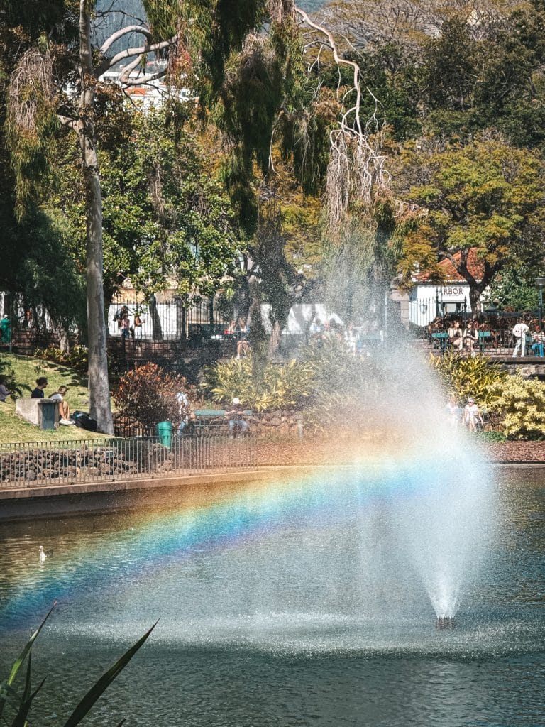 A fountain with a rainbow in the municipal park in Funchal