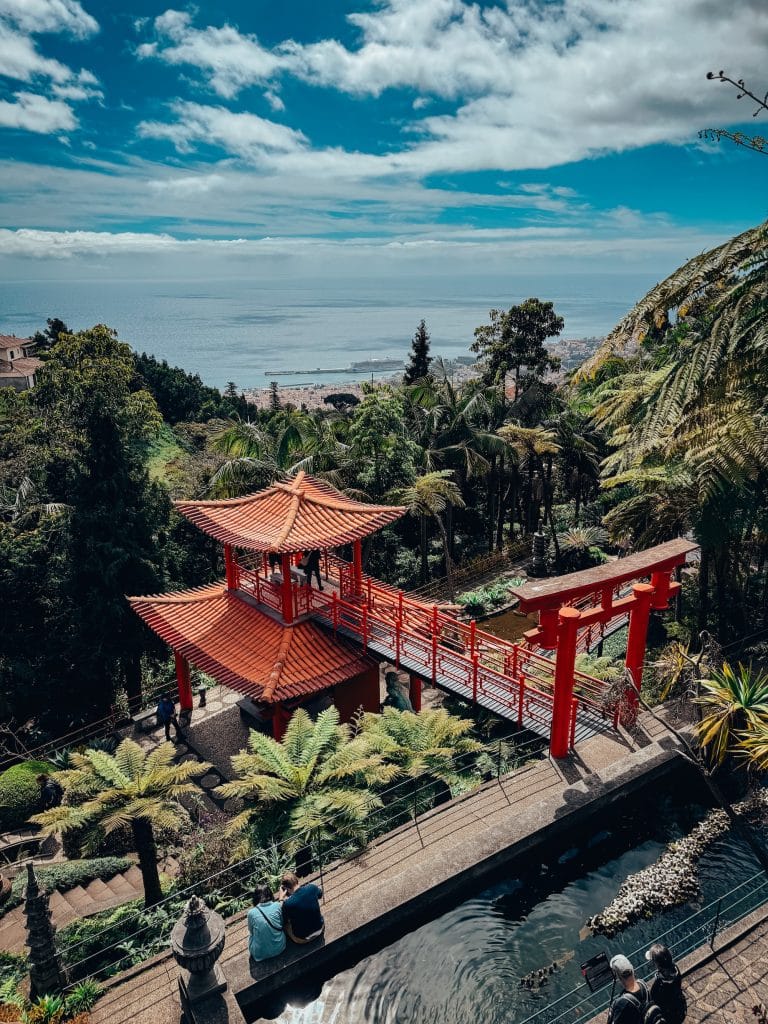The Monte Palace oriental garden with red pagodas, a torii gate and a pond against a panorama of Funchal and the Atlantic Ocean. Photo: Ewelina Podrez-Siama 2025