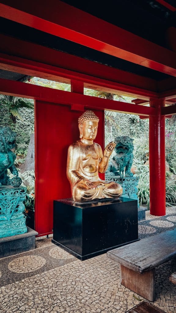 A golden Buddha statue in one of the pagodas of the Monte Palace oriental garden, surrounded by bronze guardian lions. Photo: Ewelina Podrez-Siama 2025