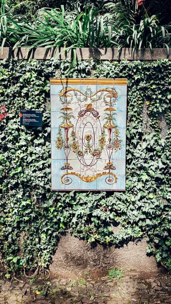 A panel of traditional Portuguese azulejos with a floral pattern, set into an ivy-covered wall at Monte Palace. Photo: Ewelina Podrez-Siama 2025