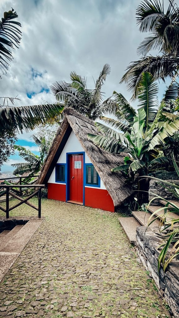 A replica of a traditional Santana house (casa de colmo) with a triangular thatched roof, in the grounds of the Monte Palace garden. Photo: Ewelina Podrez-Siama 2025