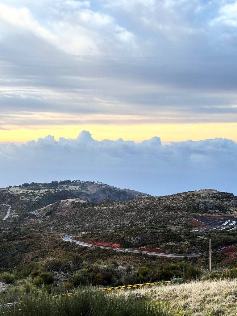 The winding road to Pico do Arieiro across the plateau, with a sea of clouds behind