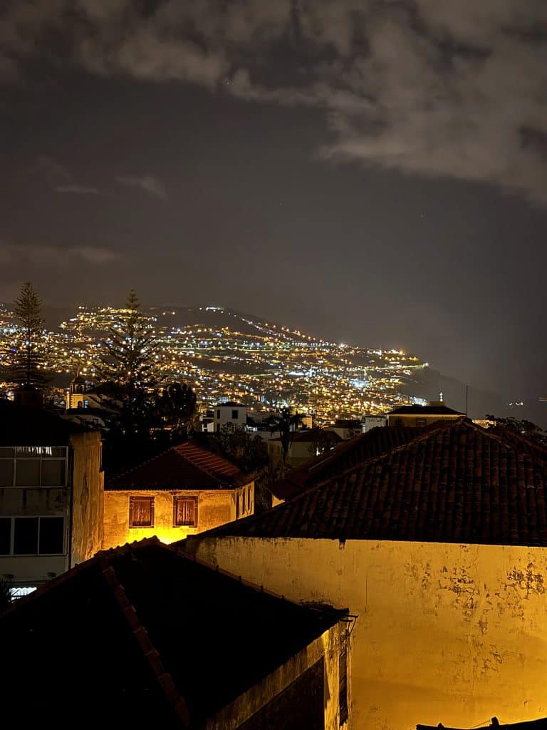 The lights of Funchal at night seen from a terrace above the rooftops