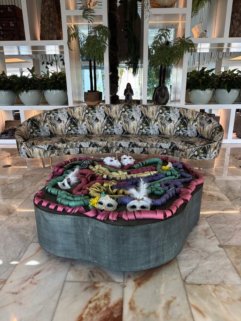 Colourful Carnival masks on a round table in a hotel lobby