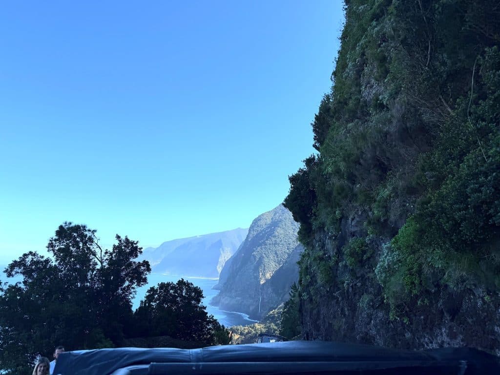 Steep cliffs of Madeira’s north coast and the ocean seen from a jeep