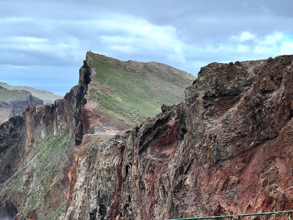 Red-brown cliffs and green slopes at Ponta de São Lourenço