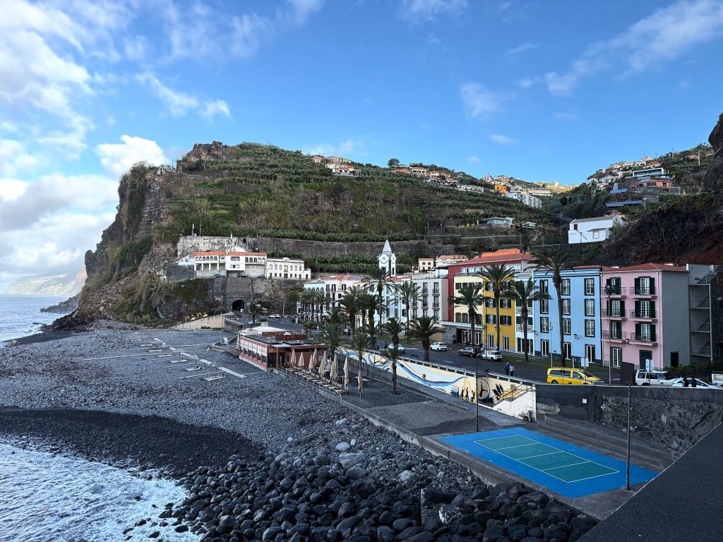 Ponta do Sol: colourful houses along the promenade below a terraced cliff
