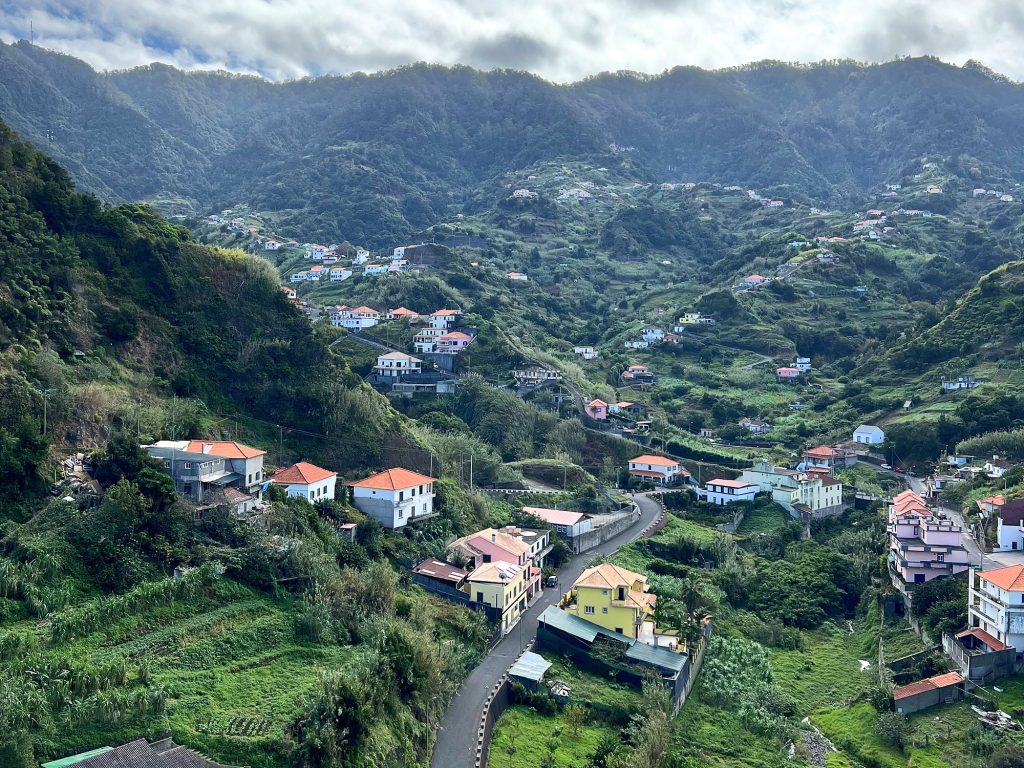 The valley above Porto da Cruz with houses and farming terraces, mountains behind