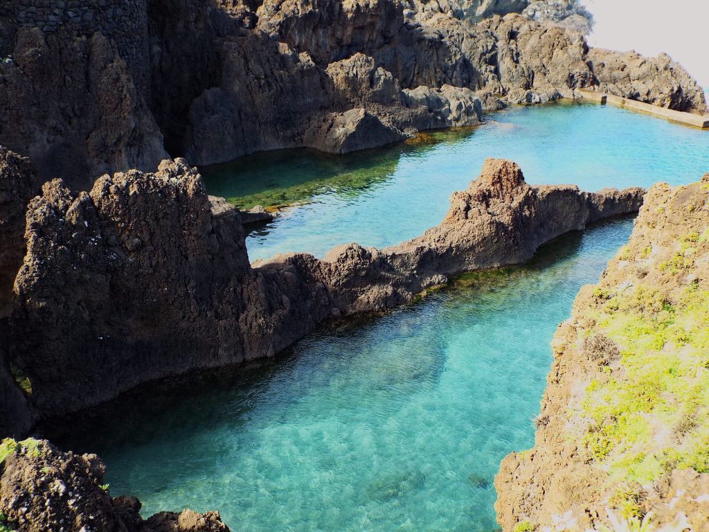 Turquoise water in a pool of solidified lava in Porto Moniz