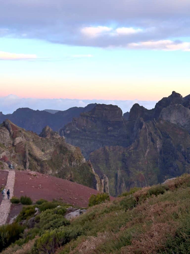 The PR1 path running along the ridge towards jagged peaks at dawn