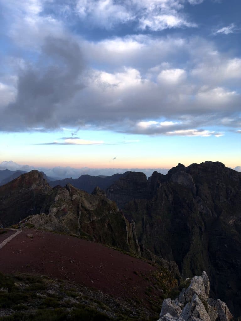 A red path on the ridge and the dark peaks of Madeira’s central massif