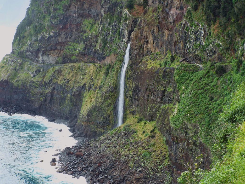 The Véu da Noiva waterfall dropping from a cliff straight into the ocean
