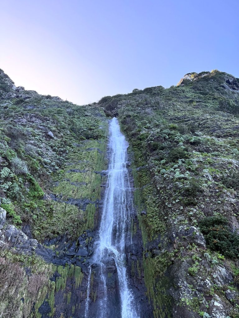 Tall waterfall running down a rock face beside the road on Madeira’s north coast