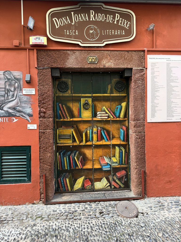 A door painted to look like bookshelves in the Zona Velha, Funchal
